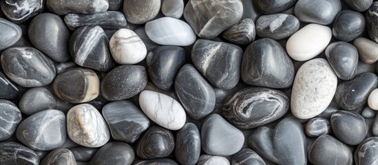 Poster - Smooth gray and white pebbles background with various textures and shapes suitable for natural decoration Copy Space