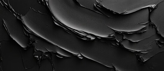 Poster - black textured surface with thick paint layers and glossy finish ideal for background use copy space