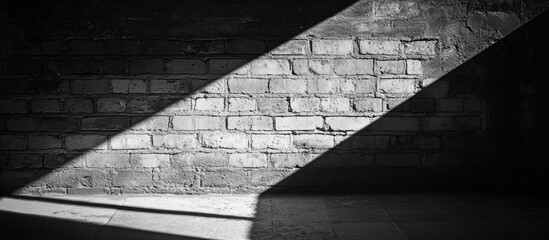 Poster - Diagonal light beam casting shadows on textured brick wall in monochrome setting with Copy Space.
