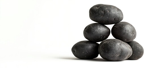 Poster - Stacked black stones on white background with copy space for text or graphics