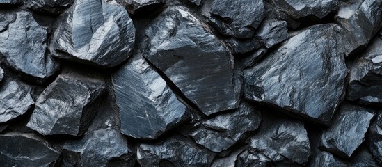 Poster - Black rock surface texture with irregular shapes and sharp edges ideal for backgrounds or overlays Copy Space