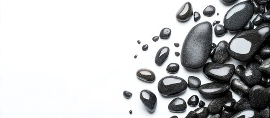 Poster - Black smooth pebbles arranged on a white background with ample copy space for text placement