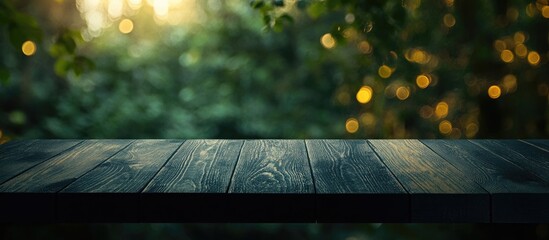 Poster - Wooden table surface with blurred green foliage and bokeh lights background ideal for product display or promotional text Copy Space