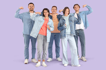 Wall Mural - Group of young people in denim clothes showing muscles on lilac background