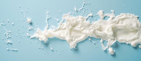 Aufkleber - Dynamic white water splash captured in freeze motion against a serene blue background ideal for design and advertising applications.