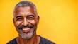 © AIArtistry - Handsome African American man with grey hair smiling against a vibrant yellow background with ample copy space for text and branding