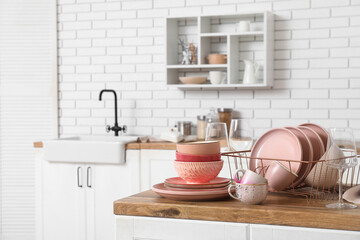 Wall Mural - Holder with clean pink dishes on counter in kitchen