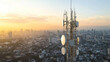 © wiparat - Telecommunication tower cellular network antenna on city background