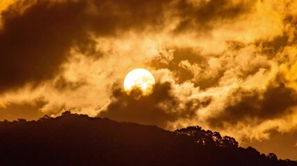 Wall Mural - breathtaking beauty of the sun rising time lapse video over a rugged mountain ridge on a cloudy morn