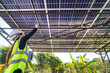 © ultramansk - Engineer inspecting solar panels under a solar-powered carport on a sunny day, ensuring optimal performance. Focus on renewable energy, sustainability, green power, and eco-friendly solar solutions.