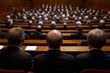 © Sergio - Group of officials in formal suits attending a legislative session in a large hall with rows of seats and focused discussions