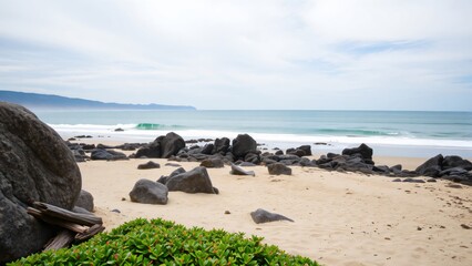 Serene Coastal Scene Sandy Beach with Dark Rocks and Rolling Waves