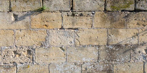 Wall Mural - background large bricks wall of yellow square rock texture of the old building facade