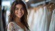 © komgritch - A joyful bride-to-be smiles while trying on wedding dresses in a boutique.