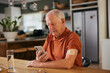 © Rido - Diabetic senior man checking glucose on digital app