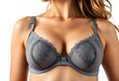 © ANMZAKARIA - Sexy young woman's breast close-up in grey lingerie bra isolated on white background. Correcting lingerie for woman. Beautiful fit girl wearing elegant bra