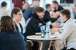 © Anton Gvozdikov - Group of professionals discussing ideas at a conference table, fostering teamwork and collaboration.