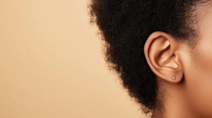 Aufkleber - Close up view of a healthy ear adorned with a small, elegant earring, emphasizing the importance of good hearing and ear care against a soft, neutral beige backdrop