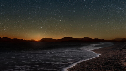 Wall Mural - a movement of stars in the night sky with the view of mountains..