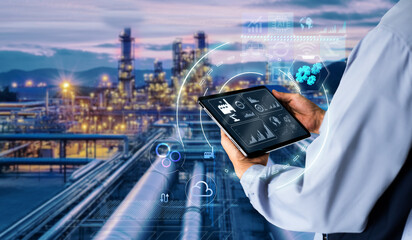 Smart industry 4.0 mangement control system concept.Hands holding tablet on blurred Chemical plant refinery industrial equipment as background