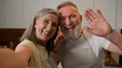 © Yuliia - Webcam view happy senior retired family couple chefs record video recipe food blog in kitchen old Caucasian grandparents woman and man talk live stream culinary hobby healthy eating love relationship