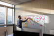 © ReeldealHD images - Businesswoman using adhesive notes in an office to brainstorm ideas