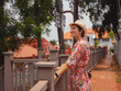 © YURII Seleznov - Young woman in ethnic dress and hat exploring the vibrant streets of Malacca, Malaysia. A blend of cultural heritage, colorful architecture, and tropical charm. Perfect travel and lifestyle moments.