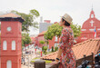 © YURII Seleznov - Young woman in ethnic dress and hat exploring the vibrant streets of Malacca, Malaysia. A blend of cultural heritage, colorful architecture, and tropical charm. Perfect travel and lifestyle moments.