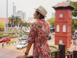 © YURII Seleznov - Young woman in ethnic dress and hat exploring the vibrant streets of Malacca, Malaysia. A blend of cultural heritage, colorful architecture, and tropical charm. Perfect travel and lifestyle moments.