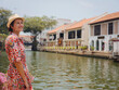 © YURII Seleznov - Young woman in ethnic dress and hat exploring the vibrant streets of Malacca, Malaysia. A blend of cultural heritage, colorful architecture, and tropical charm. Perfect travel and lifestyle moments.