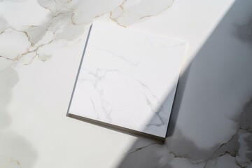 Poster - Sunlight casting a shadow on a square marble tile resting on a marble surface, creating an elegant and minimalist aesthetic