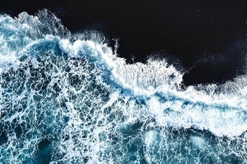 Poster - Aerial view of ocean waves with foamy white crests against a dark contrasting background.