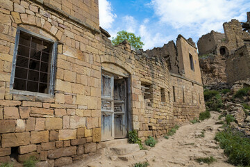 Wall Mural - Ruins of an old traditional mountain house in the abandoned village of Gamsutl on a May morning. Dagestan. Russian Federation