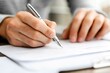 © Sanchai - A close-up of a person fidgeting with a pen during a tense job interview, their hands trembling slightly