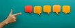 © GreenOptix - Hand pointing at speech bubbles on green background for communication concept