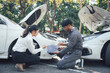 © Kritdanai - Auto Repair Consultation: A mechanic and a female customer discuss a car repair, highlighting the importance of communication and trust in the automotive industry.
