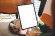 © Farknot Architect - Mockup image of a woman holding digital tablet with blank desktop screen in cafe