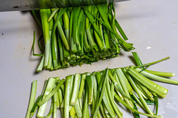 Wall Mural - cutting the fresh chives on the cutting board