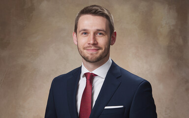 A professional businessman portrait with a studio background.