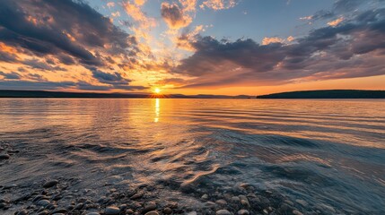 Canvas Print - Sunset over a calm lake with rippling water and colorful clouds reflecting in the sky Copy Space