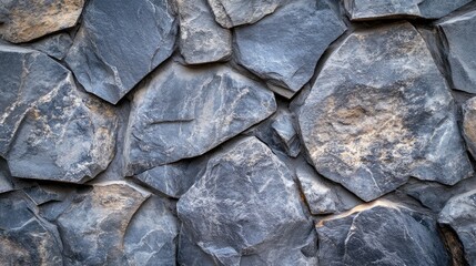 Poster - Textured stone wall background composed of irregular dark gray rocks with natural variations and rough surfaces ideal for use as a backdrop Copy Space