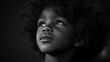 © DigitalDruid - Young child with curly hair in black and white portrait looking upward with soft lighting and deep expression Copy Space
