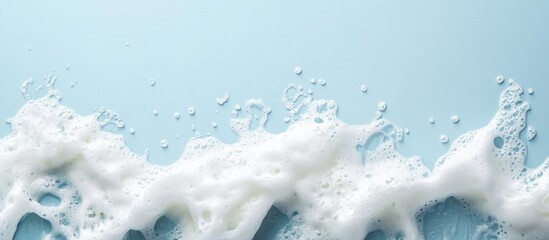 Poster - Soap bubbles and foam on light blue background with copy space for text or branding elements.