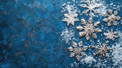 Poster - Decorative silver snowflakes on textured blue background with snowflakes and copy space for holiday season themes