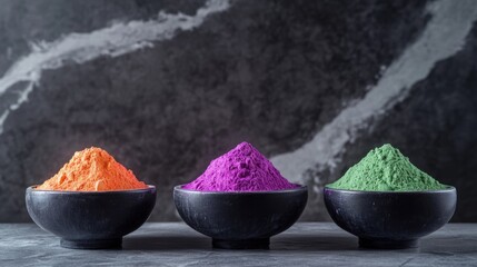 Poster - Colorful powdered pigments in black bowls displayed on a textured gray background Copy Space