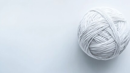 Poster - White yarn ball on a light background with copy space for text or branding.