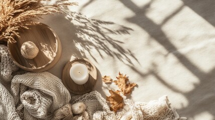 Poster - Warm cozy home interior flat lay with natural materials candle decorative elements and cozy textiles with soft light and shadows Copy Space