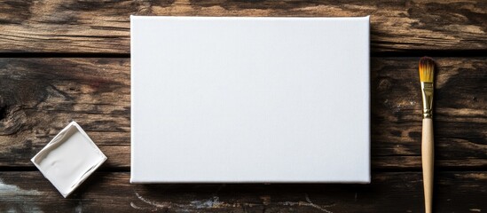 Aufkleber - Blank canvas and paintbrush on wooden table for art mockup with space for text and creative ideas for artists and designers