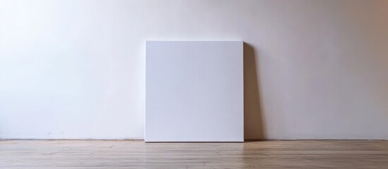 Aufkleber - Blank canvas on minimalistic white wall with wooden floor perfect for showcasing art or adding personalized text and design elements.