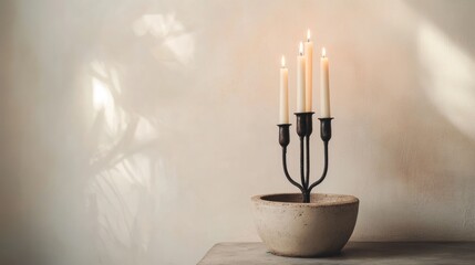 Poster - Candle holder with five lit candles in a stone bowl on a textured background with natural light and shadows Copy Space